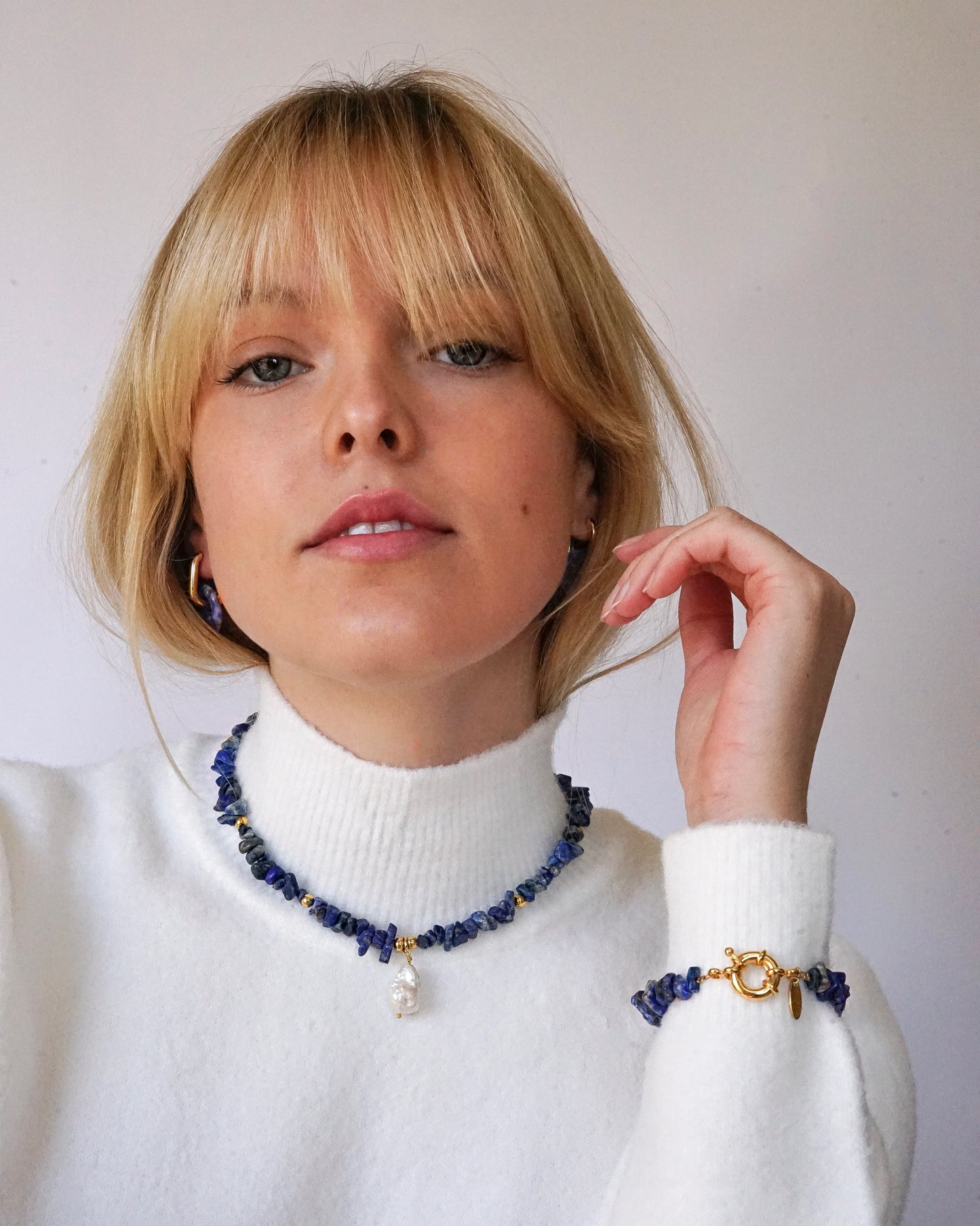 Model in lapis lazuli necklace and bracelet with big freshwater pearl and sailor clasp.