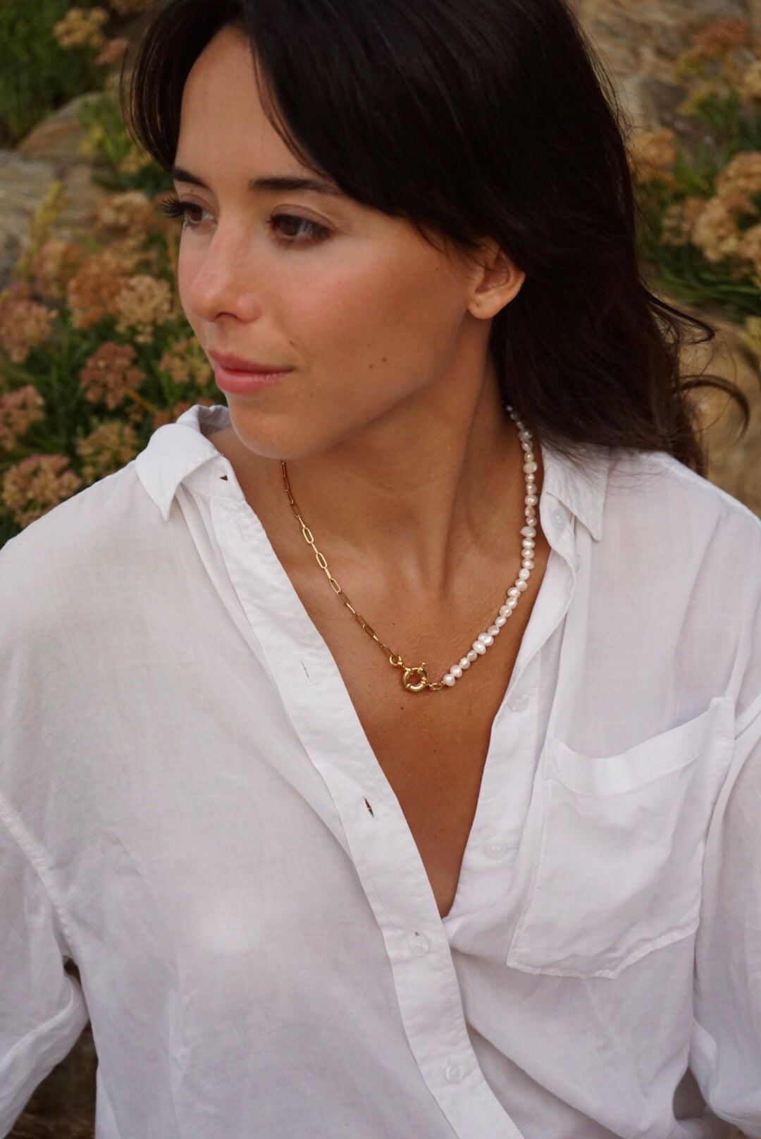 Girl with fringe with natural pearls and 24K gold Rocap Jewelry necklace with sailor clasp and white shirt