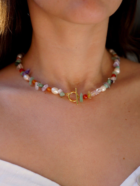 Colourful gemstone necklace with circle clasp in the front.