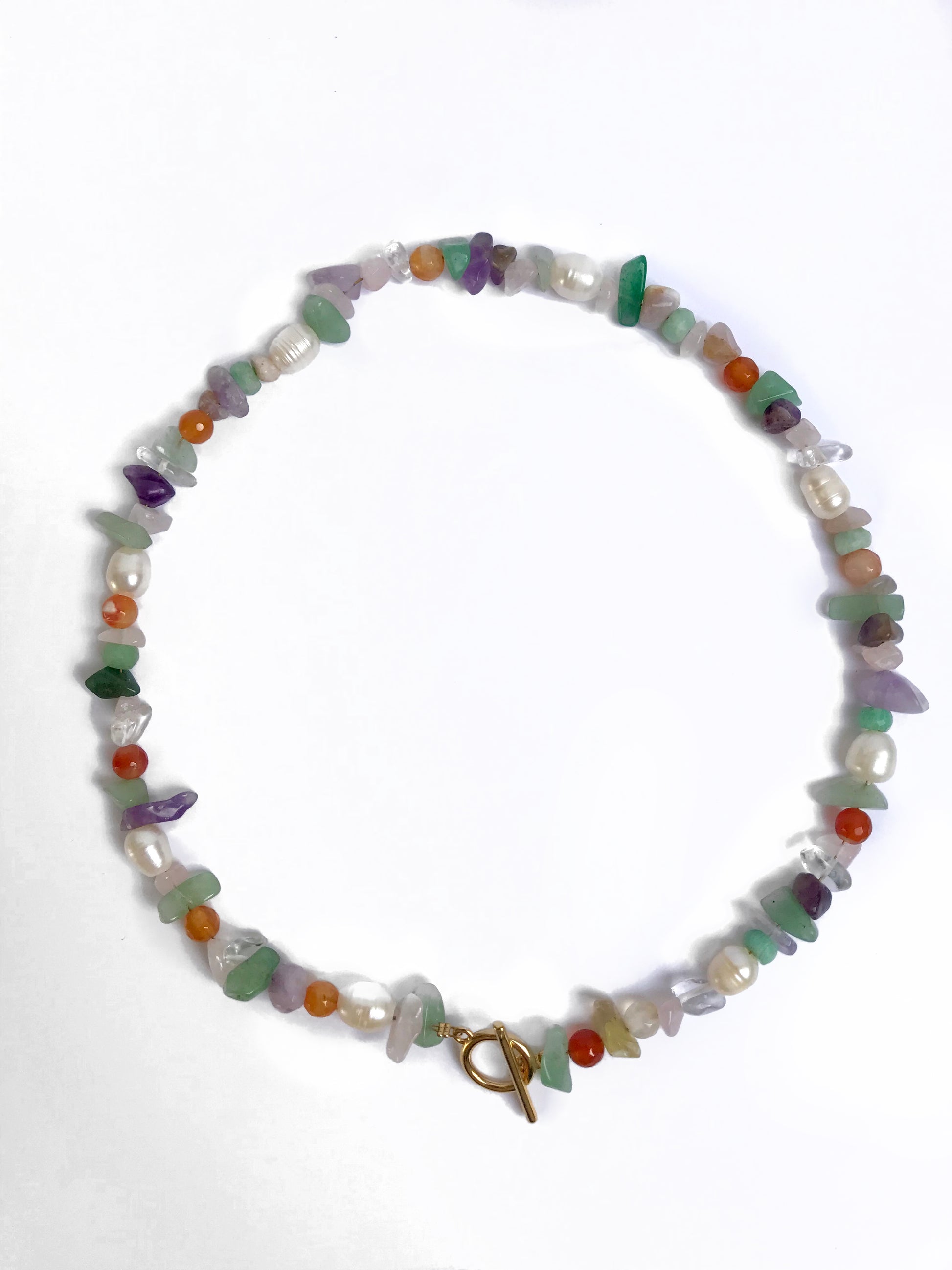 Multi colour gemstone necklace with circle clasp in the front.