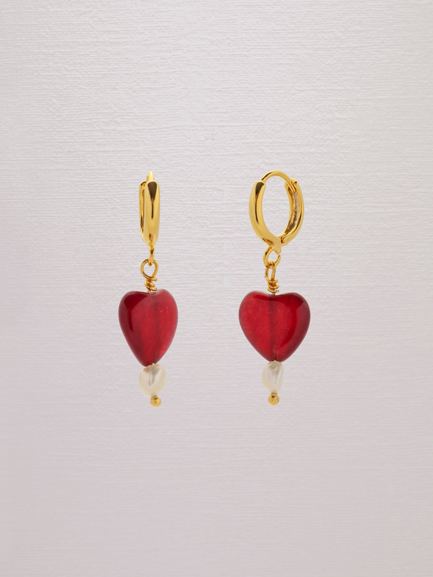 Red gemstone heart earring with a freshwater pearl and 24k gold-plated hoop.